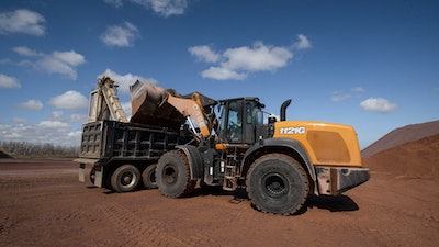 Case 1121G wheel loader loading truck with dirt