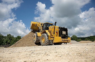 Cat 988 GC wheel loader dumping onto gravel pile rear view