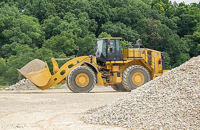 Cat 988 GC wheel loader side view behind gravel pile