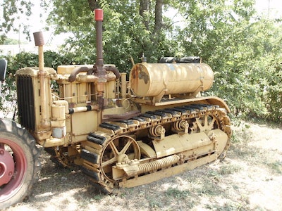 old rusted 1929 Cat 30 by trees