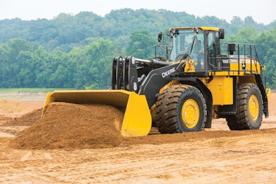 John Deere 944K hybrid wheel loader pushing dirt