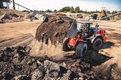 Hitachi ZW220 wheel loader dumps dirt