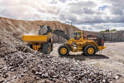 Volvo L350H wheel loader unloading rocks in truck bed