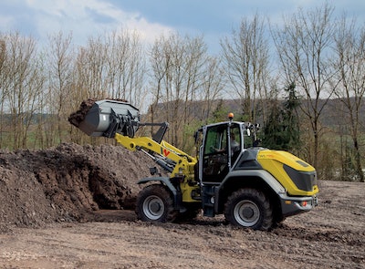 Wacker Neuson WL95 Wheel Loader ready to dump load on dirt pile