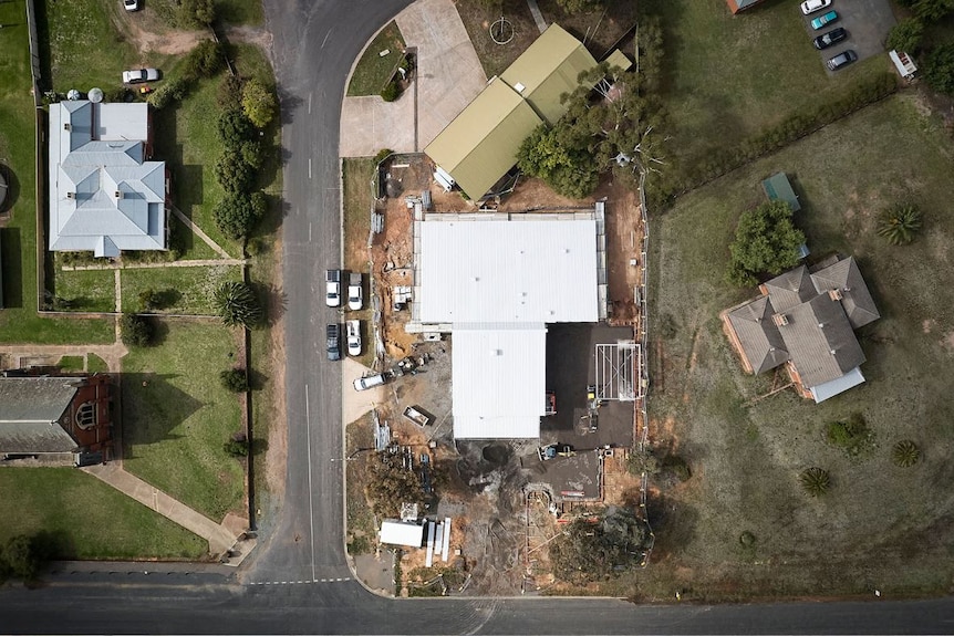 An aerial drone photo show two buildings situated next to each other