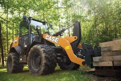 Case 221F compact wheel loader lifting pavers