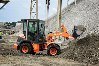 Hitachi ZW30 compact wheel loader lifting load of dirt