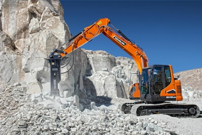 Develon excavator with HB-series breaker breaking rock cliff