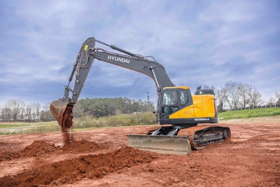 side view Hyundai HX355ALCR excavator digging in red clay