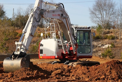 Takeuchi TB2150 excavator digging in red earth