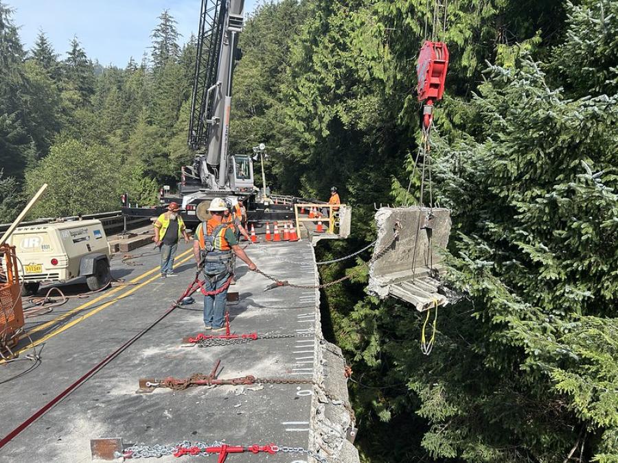 Workers remove a damaged concrete section of the bridge dating to its 1937 construction.