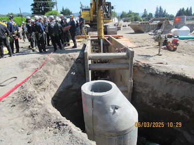 The upright manhole inside the 10-foot-deep trench June 3 with rescuers on the scene after a worker was crushed by a falling excavator bucket in Washington.