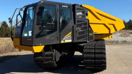 Tracked dump truck with a yellow dumping bed and black cab, used for hauling soil and debris on construction sites.