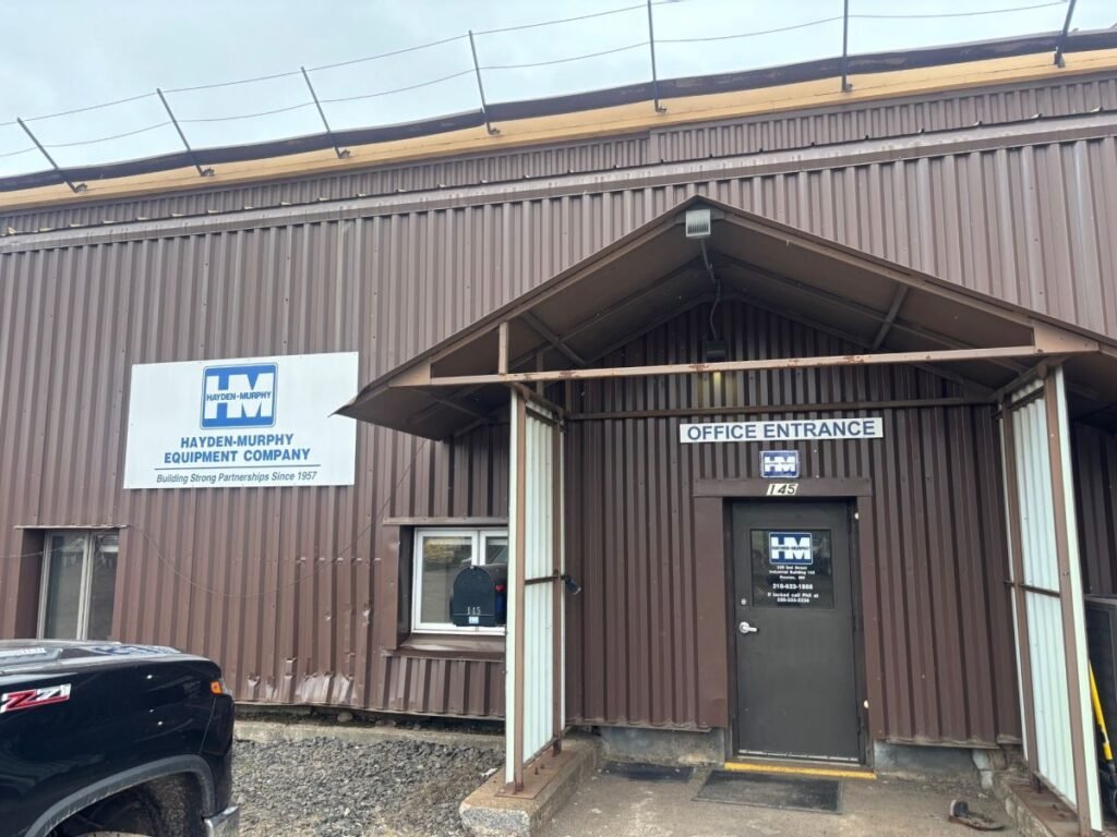 Industrial building with a blue and white Hayden-Murphy Equipment Company sign and an office entrance door labeled 'Office Entrance'.