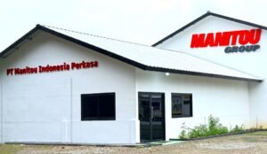 White industrial building with red 'MANITOU GROUP' sign on the roof and 'PT Manitou Indonesia Perkasa' lettering on the front wall