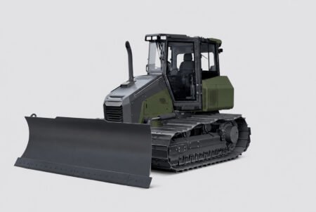 Bulldozer on tracks with a large front blade, gray and green cabin, against a light background.