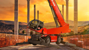 1783453831_63965_en_20799_66120_magni-rth-17151-tcpng - Machines Wiki Red mobile crane with outriggers extended on a construction site at sunset.