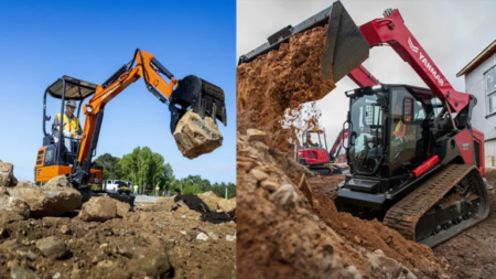 Two excavators on a construction site moving dirt and rocks, one lifting a large rock, the other dumping soil down a slope on the right side of the frame.