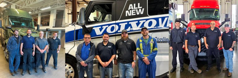 Four mechanics stand in a workshop beside a green semi-truck in a service bay.