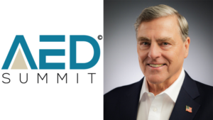 Split image: AED Summit logo on the left and a smiling man in a dark suit with a US flag lapel pin on the right.